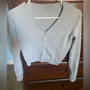 Cropped light blue long sleeve top.